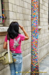 A column decorated with colourful museum visitor badges